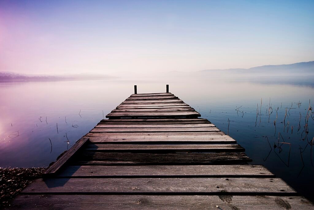 Italy, Piedmont, jetty at Lago Viverone at twilight