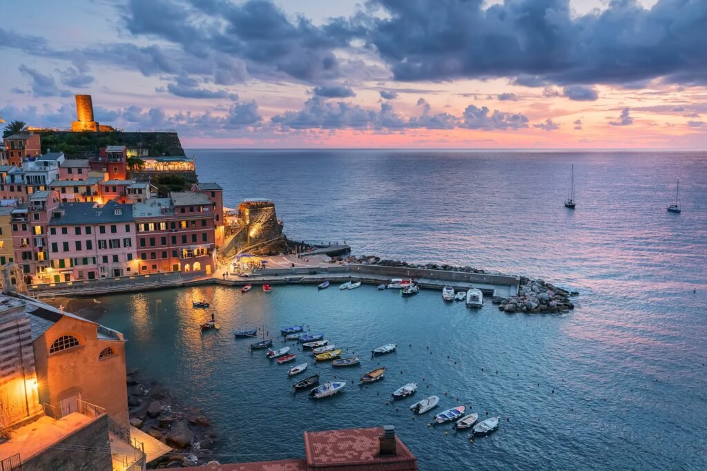 Pink sunset in Liguria. Small city Vernazza in Italy, Cinque Terre. Mediterranean culture