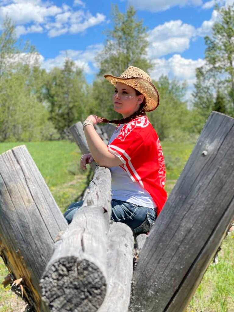 Profile young woman wearing cowboy hat in tranquil setting looking thoughtful, pensive mood.