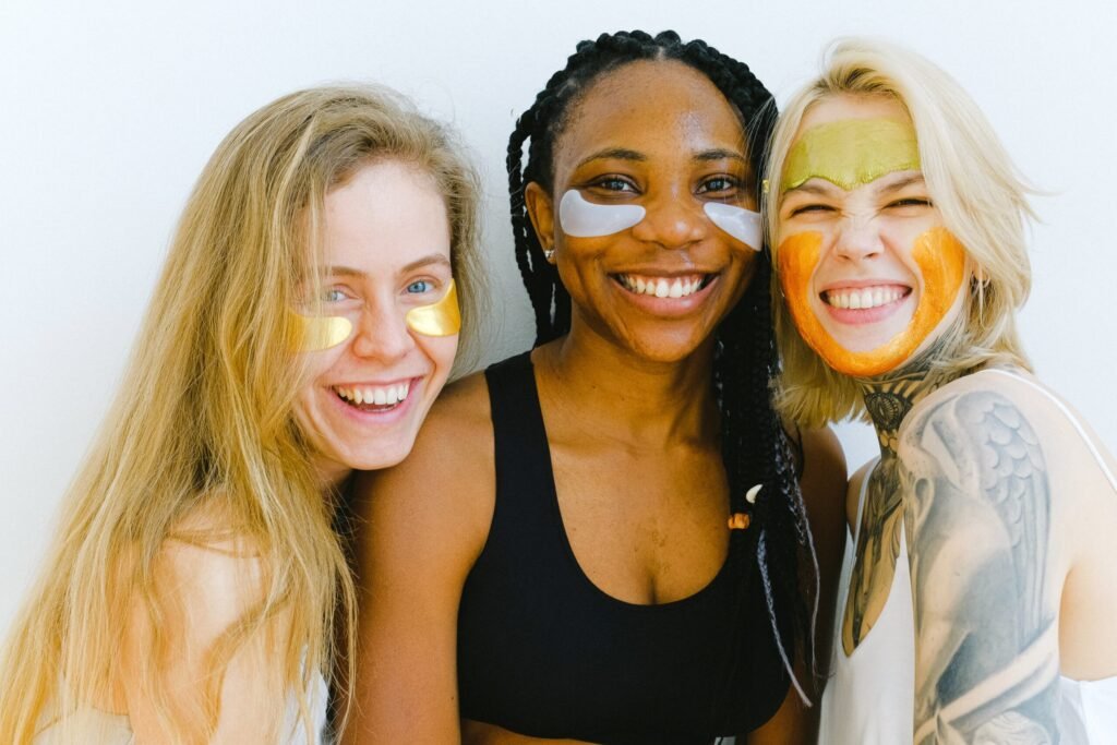 Happy women with cosmetic masks on face
