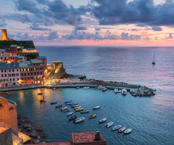 Pink sunset in Liguria. Small city Vernazza in Italy, Cinque Terre. Mediterranean culture